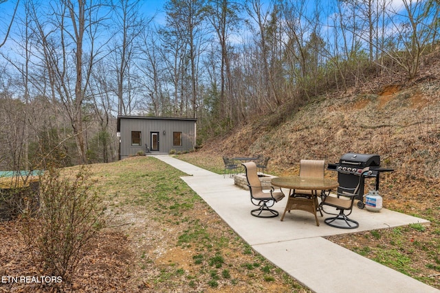 view of yard featuring an outbuilding and a patio