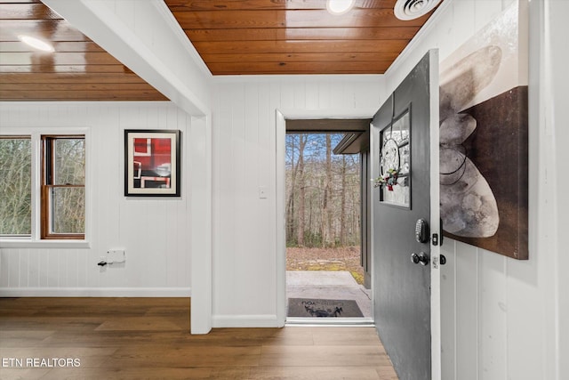 entryway with hardwood / wood-style floors, crown molding, plenty of natural light, and wooden ceiling