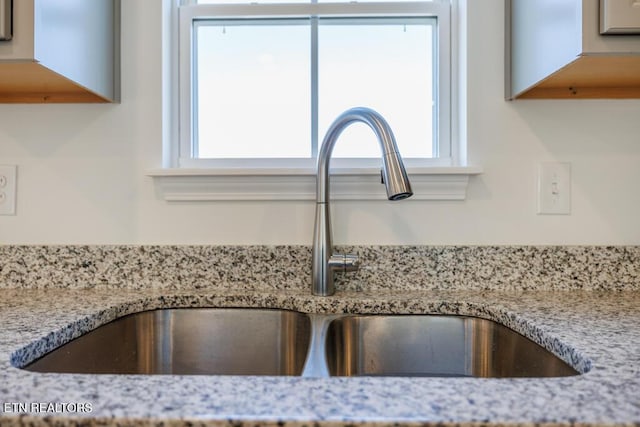 room details with sink and light stone countertops