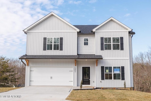 view of front of home featuring a garage and a front lawn