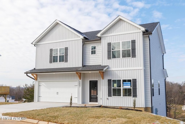 view of front of property with a garage and a front lawn