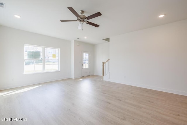 empty room with light hardwood / wood-style floors and ceiling fan