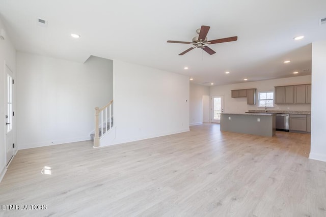 unfurnished living room with light hardwood / wood-style flooring and ceiling fan