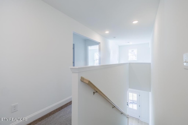 hallway with carpet floors