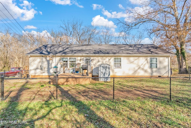 rear view of house featuring a deck and a yard