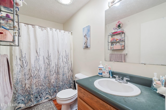 bathroom featuring hardwood / wood-style flooring, vanity, a textured ceiling, and toilet