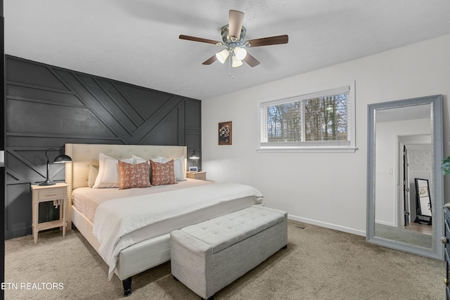 bedroom featuring ceiling fan and light carpet