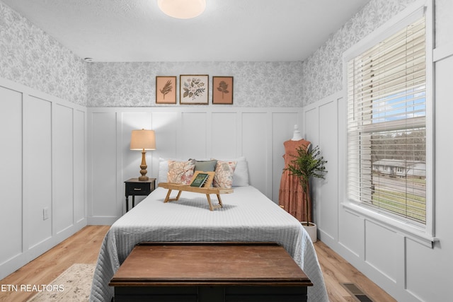 bedroom featuring light hardwood / wood-style floors and multiple windows