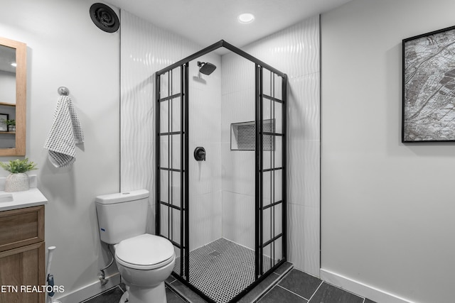 bathroom with a tile shower, tile patterned flooring, vanity, and toilet