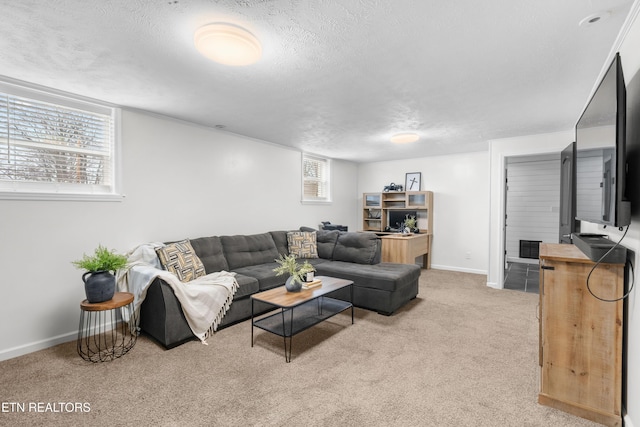 living room featuring light carpet and a textured ceiling