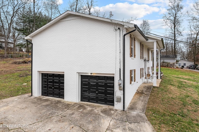 view of property exterior featuring a lawn and a garage