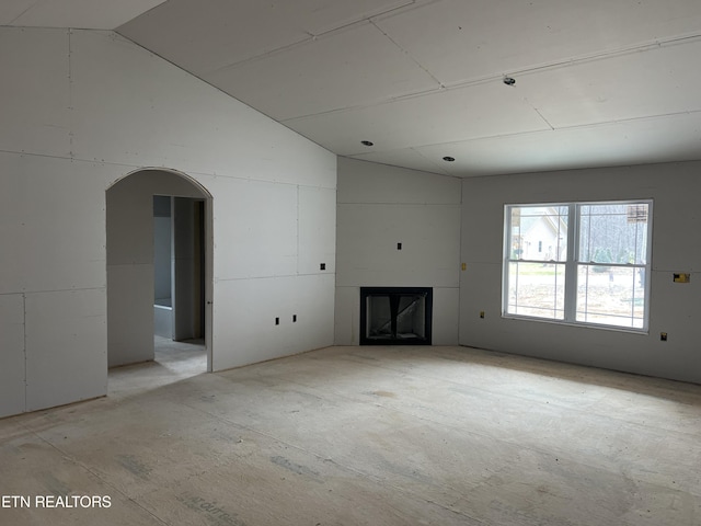 unfurnished living room with lofted ceiling