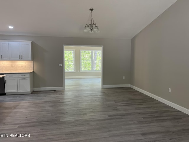 150 Hunterwood Ln, Fairfield Glade, TN 38558 - unfurnished dining area with dark wood-style floors, a notable chandelier, and baseboards