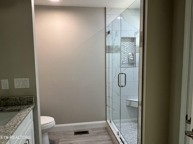 150 Hunterwood Ln, Fairfield Glade, TN 38558 - bathroom with vanity, toilet, a stall shower, visible vents, and baseboards
