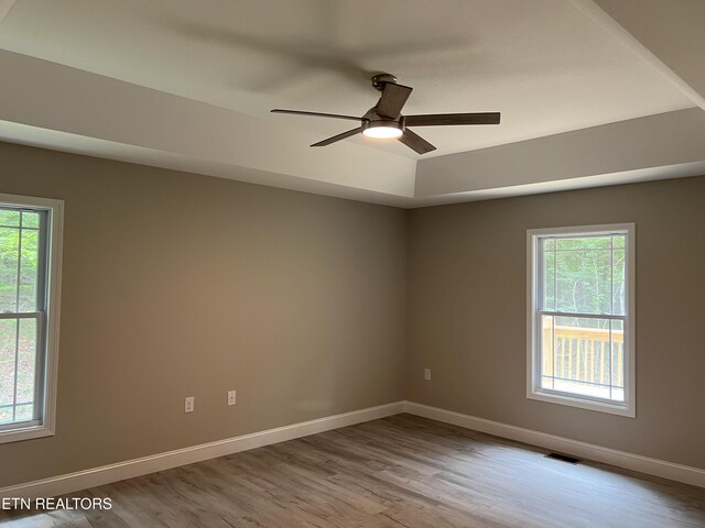 150 Hunterwood Ln, Fairfield Glade, TN 38558 - spare room with healthy amount of natural light, wood finished floors, and a ceiling fan