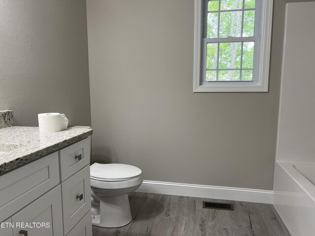 150 Hunterwood Ln, Fairfield Glade, TN 38558 - full bath with wood finished floors, baseboards, vanity, and toilet