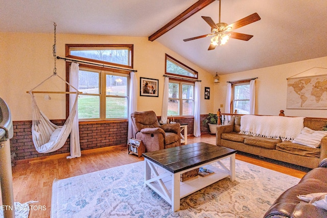 living room with lofted ceiling with beams, light hardwood / wood-style floors, and ceiling fan