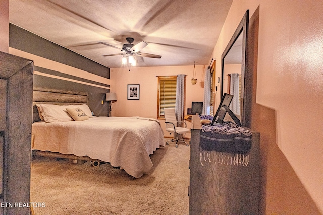 carpeted bedroom with a textured ceiling and ceiling fan