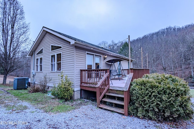 exterior space featuring a wooden deck and central AC unit