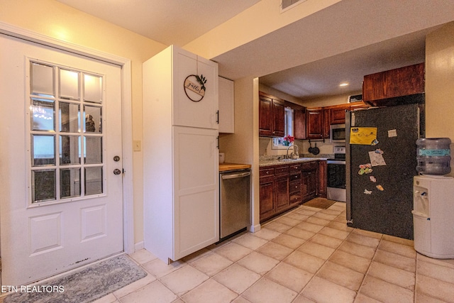 kitchen with sink, dark brown cabinets, and appliances with stainless steel finishes