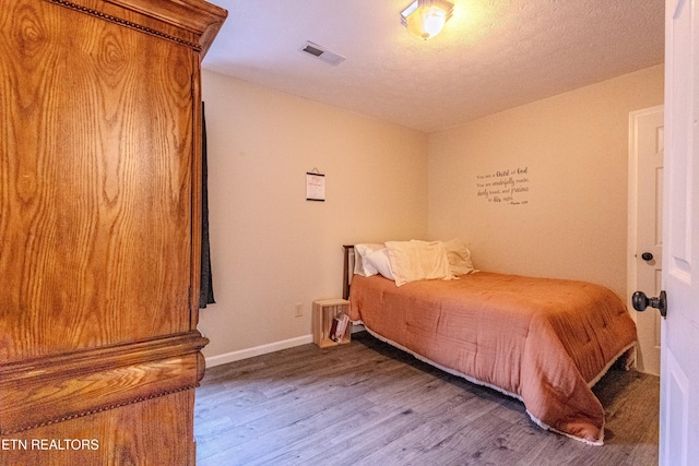 bedroom with hardwood / wood-style floors