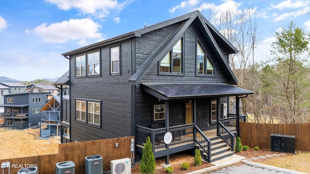 view of front of house with central AC, ac unit, and a porch