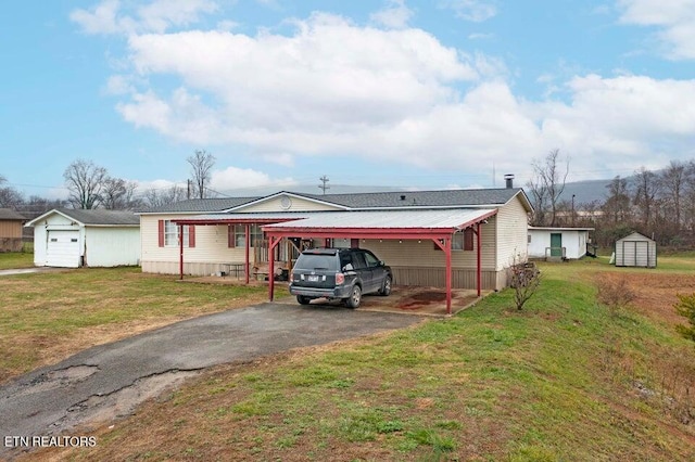 view of front of house with a front yard, a shed, and a carport