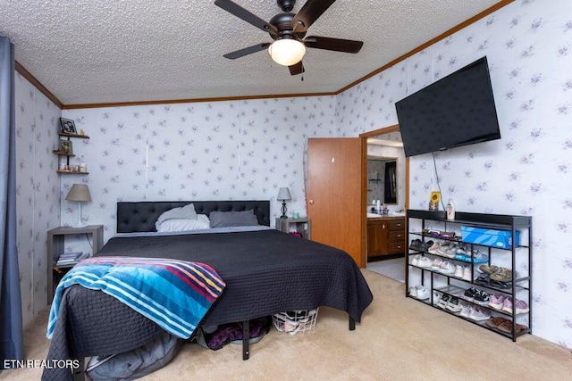 carpeted bedroom featuring a textured ceiling, ceiling fan, ornamental molding, and connected bathroom