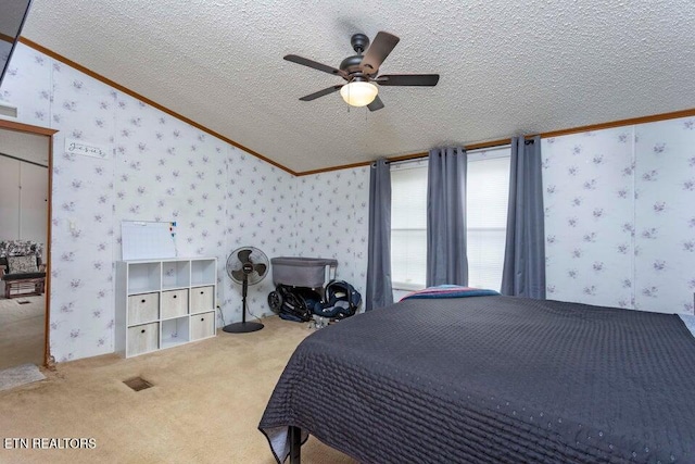 bedroom featuring carpet, ceiling fan, crown molding, and a textured ceiling