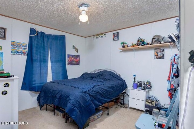 bedroom featuring ceiling fan, light colored carpet, and a textured ceiling