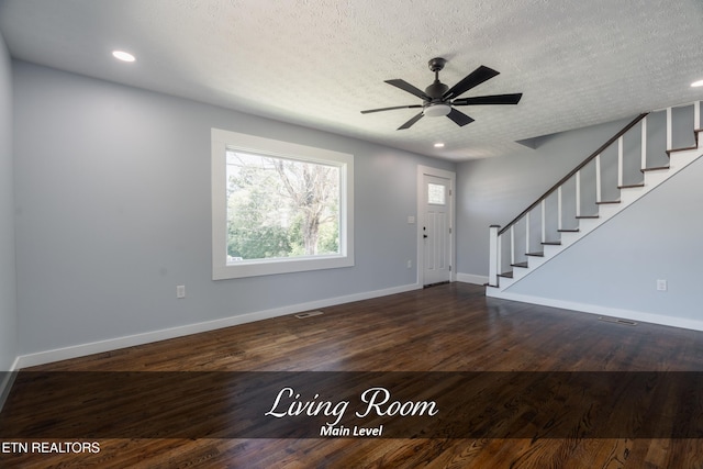 entryway featuring dark hardwood / wood-style floors, ceiling fan, and a textured ceiling