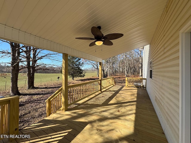 deck featuring ceiling fan and a rural view