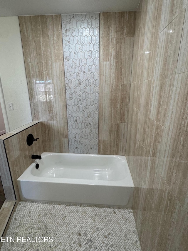 bathroom featuring tile patterned flooring and tile walls