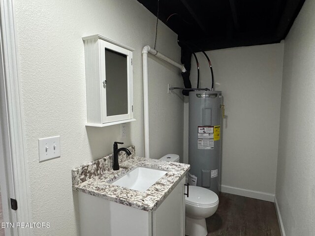 bathroom featuring vanity, hardwood / wood-style flooring, electric water heater, and toilet