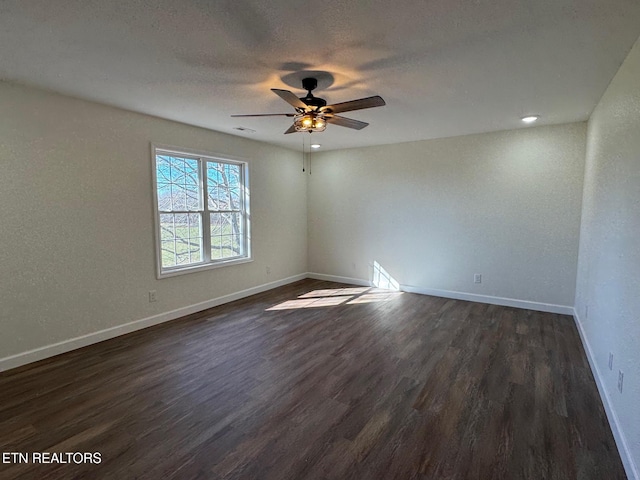 unfurnished room with dark hardwood / wood-style flooring, ceiling fan, and a textured ceiling