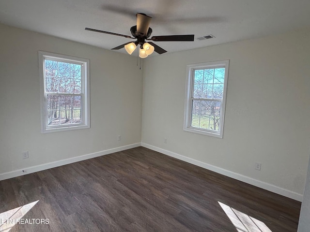 empty room featuring dark hardwood / wood-style floors and ceiling fan