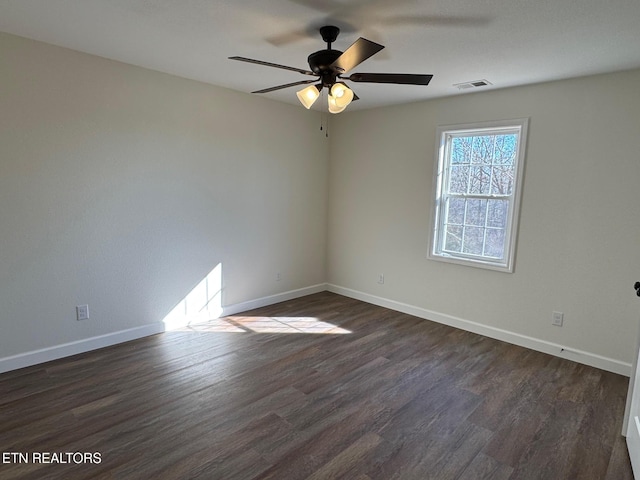 unfurnished room with dark hardwood / wood-style floors and ceiling fan