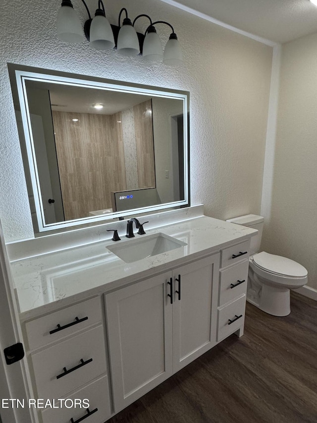 bathroom with walk in shower, wood-type flooring, toilet, and vanity