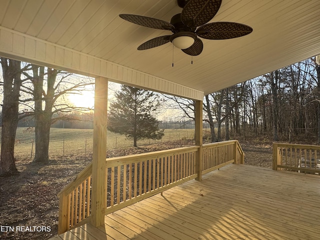 deck at dusk featuring ceiling fan and a rural view