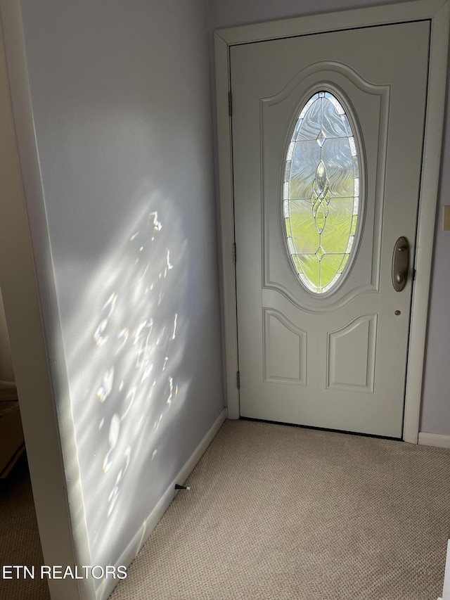 doorway to outside featuring light carpet