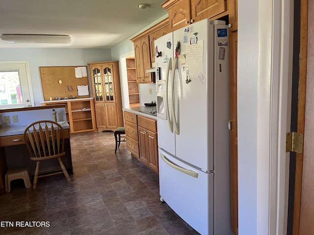 kitchen featuring white refrigerator with ice dispenser