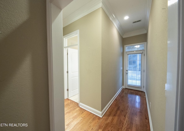 hallway featuring hardwood / wood-style flooring and ornamental molding