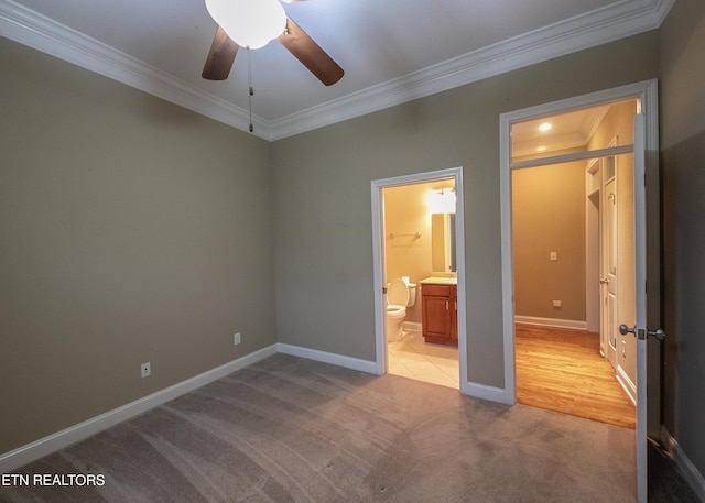 unfurnished bedroom with light colored carpet, ceiling fan, ornamental molding, and ensuite bathroom