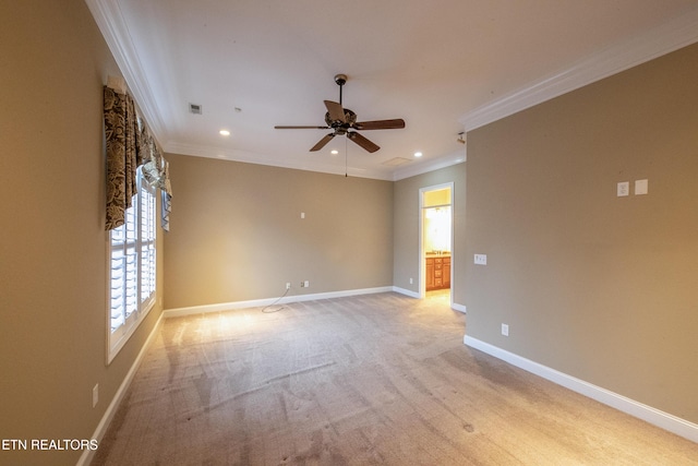 unfurnished room with ceiling fan, plenty of natural light, light carpet, and ornamental molding