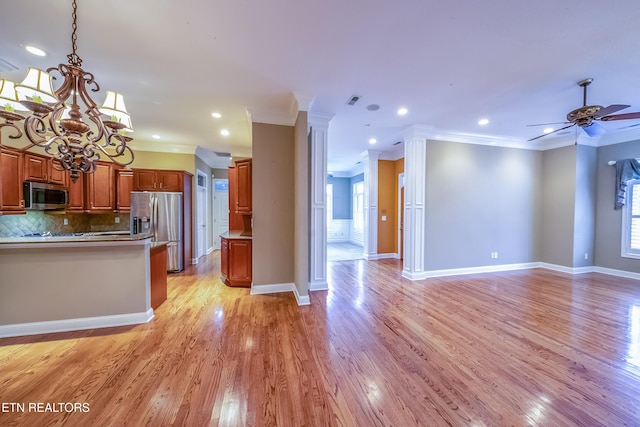 kitchen with backsplash, light hardwood / wood-style floors, crown molding, and appliances with stainless steel finishes