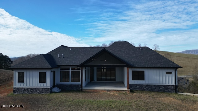 rear view of property featuring a patio area and a lawn