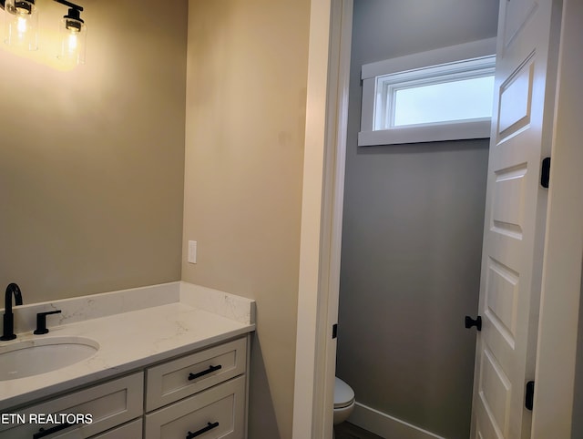 bathroom featuring vanity and toilet