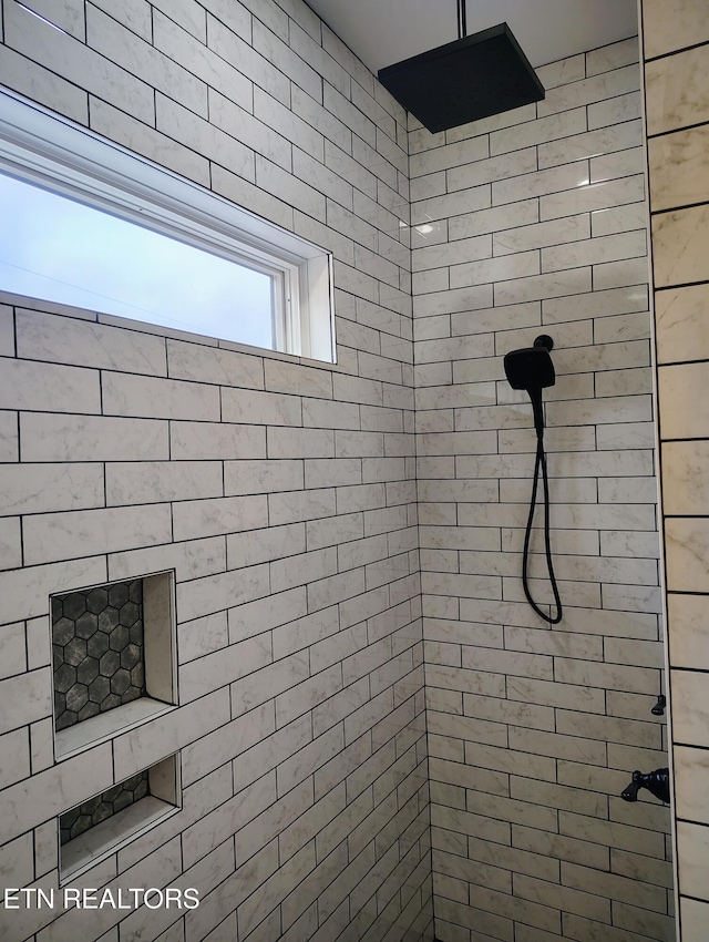 bathroom with tiled shower