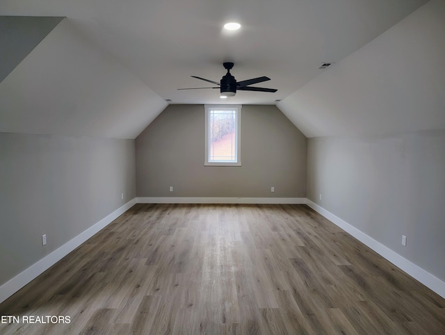 additional living space featuring ceiling fan, lofted ceiling, and light wood-type flooring