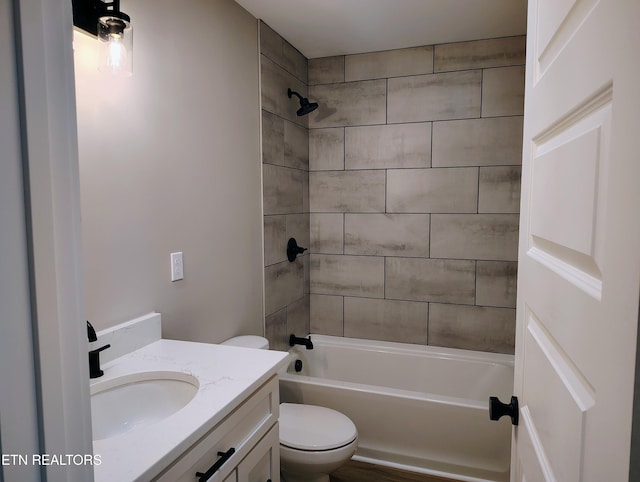 full bathroom featuring vanity, toilet, and tiled shower / bath combo